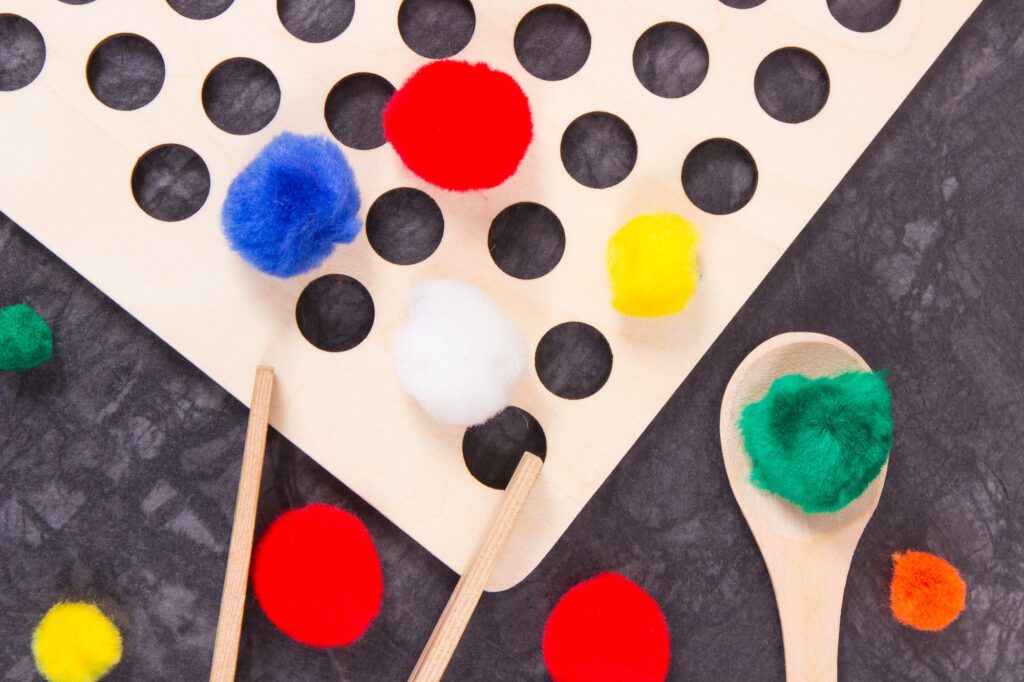Colorful pompoms using for playing and development of kids motor skills,
