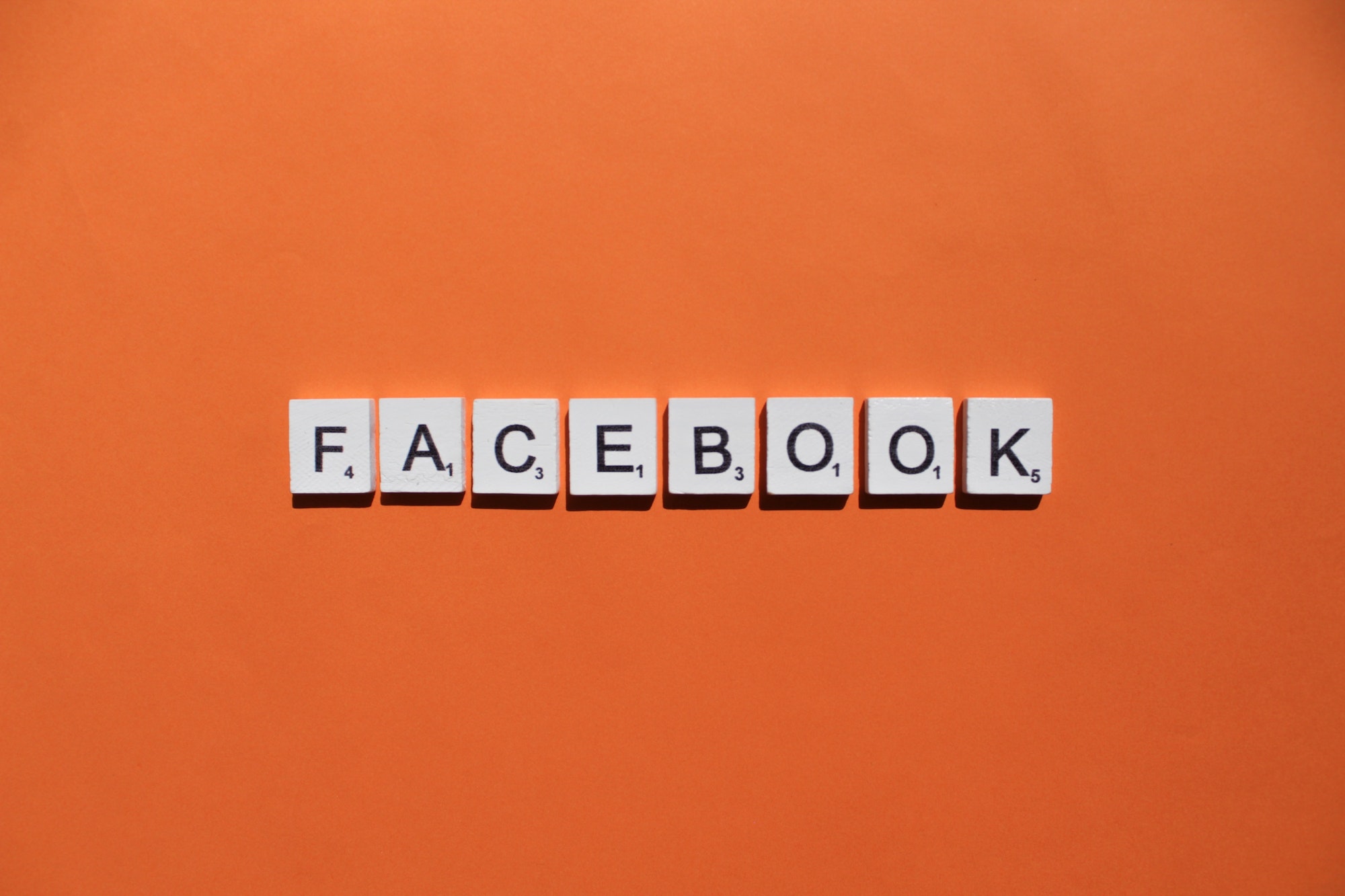 Facebook scrabble letters word on a orange background